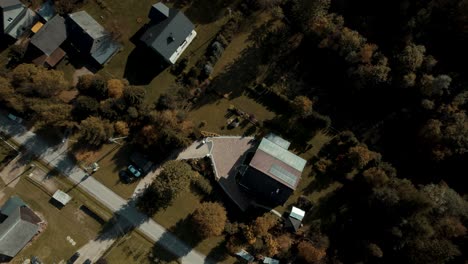 Bird-eye-view-of-single-family-house-with-solar-panels-surrounded-by-trees