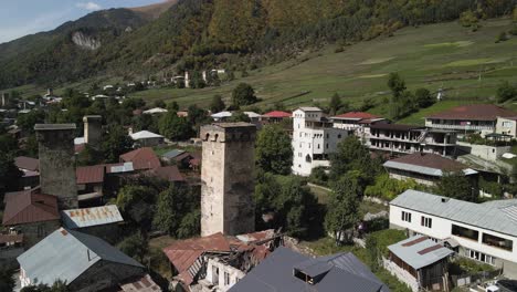 Vista-De-Drones-De-La-Montaña-Residencial-Y-Del-Cáucaso-En-El-Fondo,-Svaneti,-Georgia