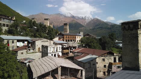 -View-of-residential-and-Caucasus-mountain-in-background,-Svaneti,-Georgia