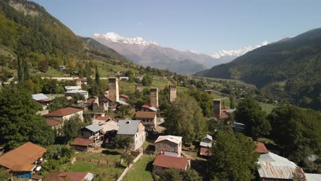 Drone-view-of-residential-and-Caucasus-mountain-in-background,-Georgia