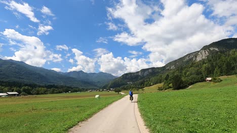 Cycling-along-a-cycle-path-in-Bohinj-during-summer-under-a-blue-sky