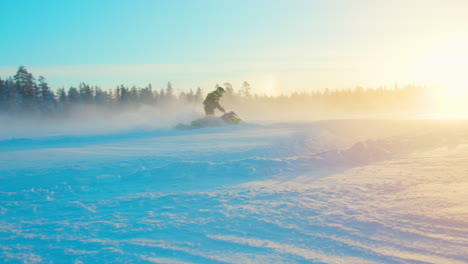 Snowmobile-rider-making-extreme-turns-in-snowy-Lapland-woodland-landscape,-Slow-motion
