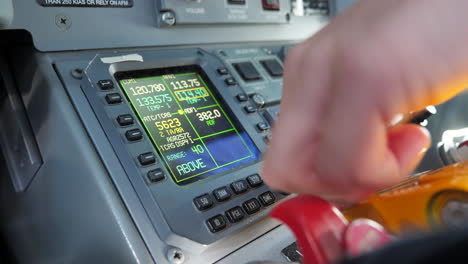 Close-up-gimbal-shot-of-pilots-hand-tuning-Radio-Management-Unit