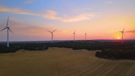 Wind-turbines-farm-silhouettes-with-beautiful-golden-hour-evening-Sun