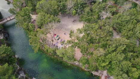 Aerial-4k-video-of-yoga-at-a-luxurious-cenote-resort-in-Mexico