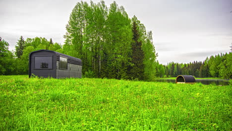 Timelapse-of-tiny-modern-homes-located-in-open-outdoors-near-a-lake-and-a-forest
