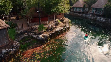 4k-drone-shot,-Paddleboarding-through-Cenote-of-Mexico-Resort