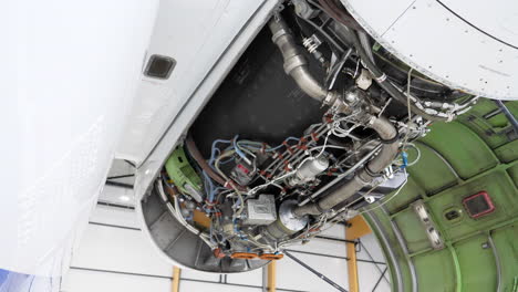 Airplane-Jet-Engine-with-Open-Cover-in-Maintenance-Hangar,-Tilt-Up
