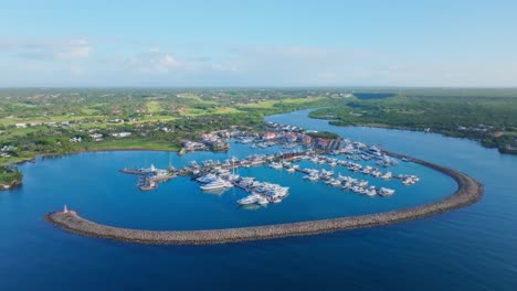 Drone-wide-shot-of-Marina-and-green-scenic-landscape-of-Dominican-Republic-in-background