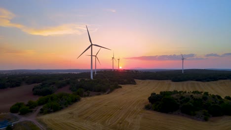 Wind-turbines-farm-silhouettes-with-beautiful-golden-hour-evening-Sun