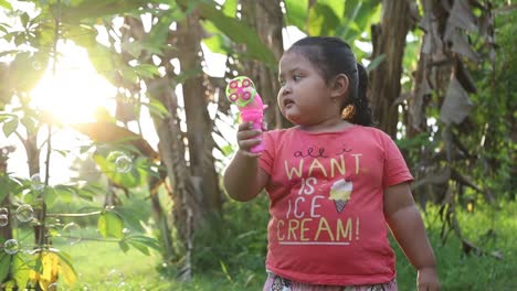 Asian-Young-child-playing-with-a-bubble-gun,-in-slow-motion