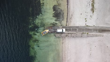 Drone-shot-of-boat-at-boat-ramp-in-lake-in-New-Zealand