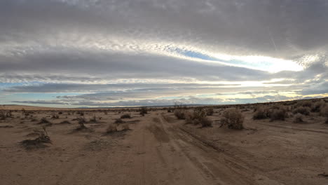 First-person-view-from-a-person-riding-a-motorcycle-along-an-off-road-trail-in-the-Mojave-Desert---POV-hyper-lapse
