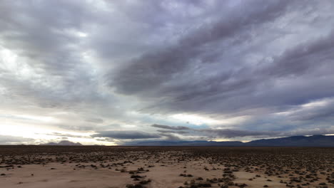 Mojave-Desert-basin-on-an-overcast-day---fast-moving-aerial-hyper-lapse-cloudscape-at-low-altitude