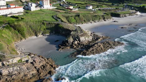 Aerial-View-Of-Praia-de-Caion-In-The-A-Coruna-Region-Of-Spain,-With-Urban-Area-On-Surrounding-Cliffs