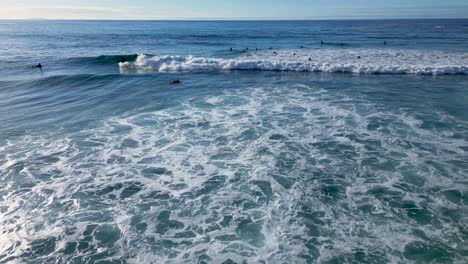 Tidal-Waves-Crashing-On-Surfers-At-The-Beach-Of-Caion-During-Summer-In-Galicia,-Spain