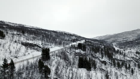 Isolated-car-driving-on-winter-iced-road-in-Norway