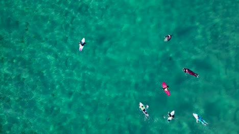 Surfers-Floating-With-Surfboards-On-Pristine-Water-Of-Caion-Beach-In-Galicia,-Spain