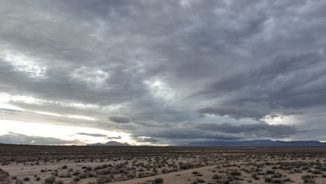 Dark-storm-clouds-over-the-Mojave-Desert's-arid-landscape-hoping-for-rain---aerial-flyover