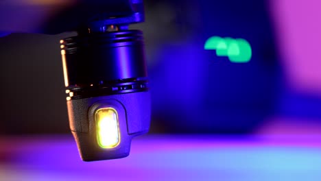 Security-light-flickering-under-the-propeller-of-a-professional-drone,-close-up-view-macro-shot