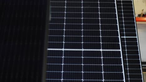 Aerial-panning-shot-of-solar-panels-on-rooftop-during-sunny-day---modern-technology