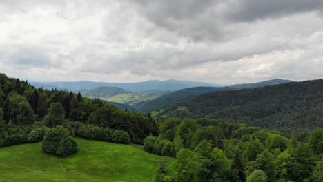 Pristine-forest-in-Beskid-Sadecki-mountains,-Poland-on-cloudy-summer-day,-aerial-panorama