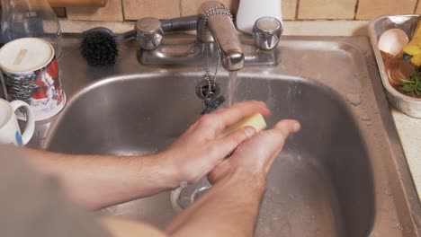 Young-man-washing-hands-with-natural-homemade-soap