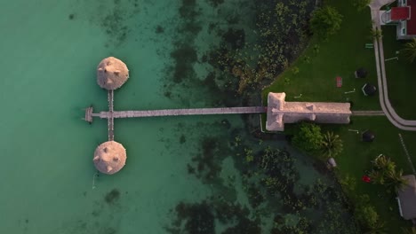 Aerial-view-above-a-wooden-pier-in-the-Bacalar,-Mexico---birds-eye,-drone-shot