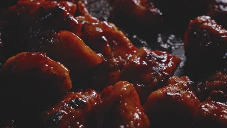 Macro-shot-of-sweet-and-sour-chicken-pieces-into-a-frying-pan