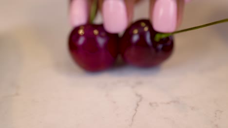 black-woman-hand-is-seductively-grabbing-cherry-vegetables-on-a-marble-kitchen-table