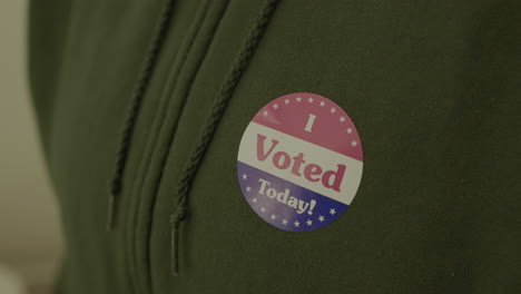 Extreme-Close-Up-of-a-Voting-Sticker-on-a-Person