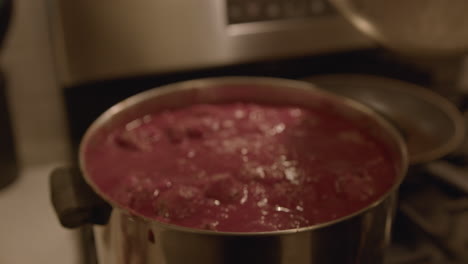 Close-Up-Slow-Motion-of-a-Woman-Cooking-Meatballs-in-a-Pot