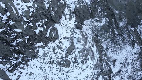 Top-down-drone-footage-of-a-refuge-in-snowy-mountains