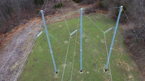 Aerial-orbit-of-3-steel-electrical-transmission-structures-in-Frankfort-Kentucky-KU-towers-with-massive-new-ceramic-bell-insulators-and-high-voltage-conductors
