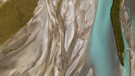 Top-down-drone-footage-of-a-glacier-river-delta-with-turquoise-water