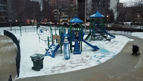Boy-with-his-father-play-in-park-in-winter-under-snow