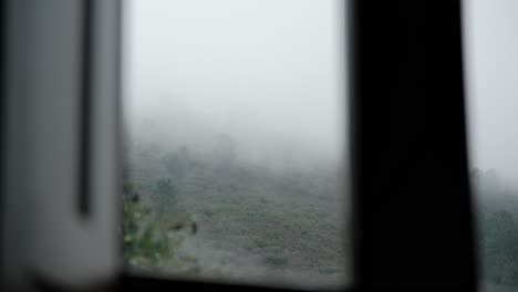 Trees-on-top-of-foggy-mountain-with-window-frame-on-foreground