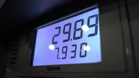 Close-up-of-screen-while-fueling-and-tanking-up-car,-expensive-at-gas-station