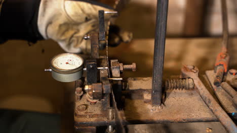 Band-saw-band-path-bending-table-with-micrometer-in-closeup-on-mechanic-at-work