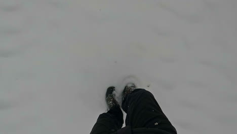 Straight-down-view-of-feet-walking-in-freshly-fallen-snow---point-of-view
