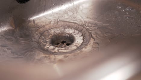 Soapy-water-flows-down-the-sink-drain