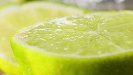 Freshly-sliced-lime,-Tracking-out-along-lime-texture-pattern,-Slow-motion-macro-shot
