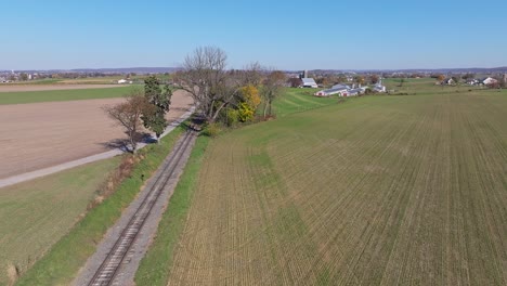 An-Aerial-View-of-a-Single-Rail-Road-Track-Going-Thru-Country-Farmlands-on-a-Sunny-Fall-Day