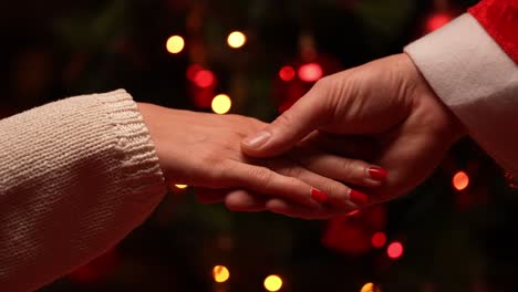 Man-and-woman-touching-hands-on-Christmas-eve