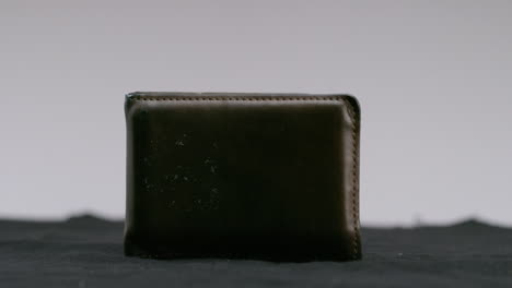 brown-leather-wallet-on-turntable