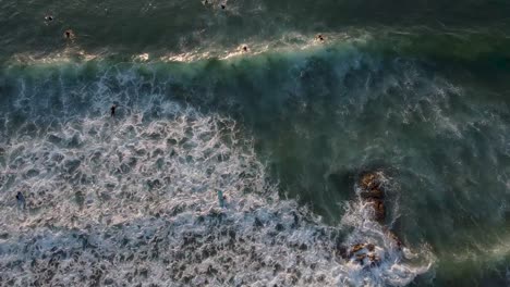 Aerial-view-of-surfers-on-a-beach-in-Portugal