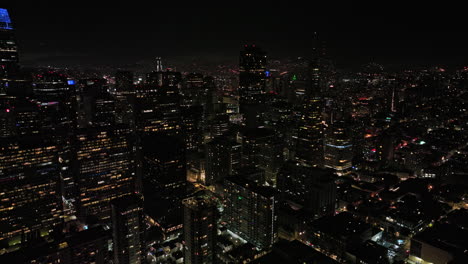 San-Francisco-California-Aerial-v133-cinematic-flyover-densely-populated-downtown,-capturing-cityscape-of-illuminated-high-rise-buildings-and-skyscrapers-at-night---Shot-with-Mavic-3-Cine---May-2022