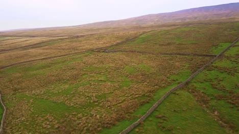 Aerial-shot-rotating-inside-Yorkshire-Dales-valley-patchwork-fields