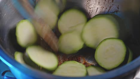 Adding-And-Stirring-Fresh-Cut-Zucchini-Into-Honey-Soy-Sauce-Marinade-In-A-Stainless-Bowl