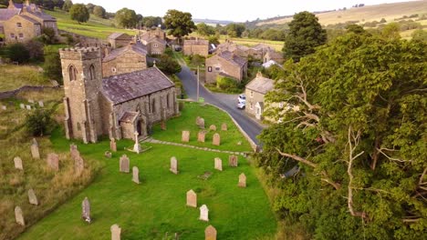 Drone-aerial-shot-old-stone-cottages-in-Yokrshire-village-with-churchyard